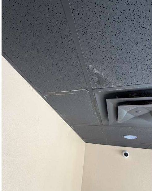 Stained ceiling tile next to an air vent