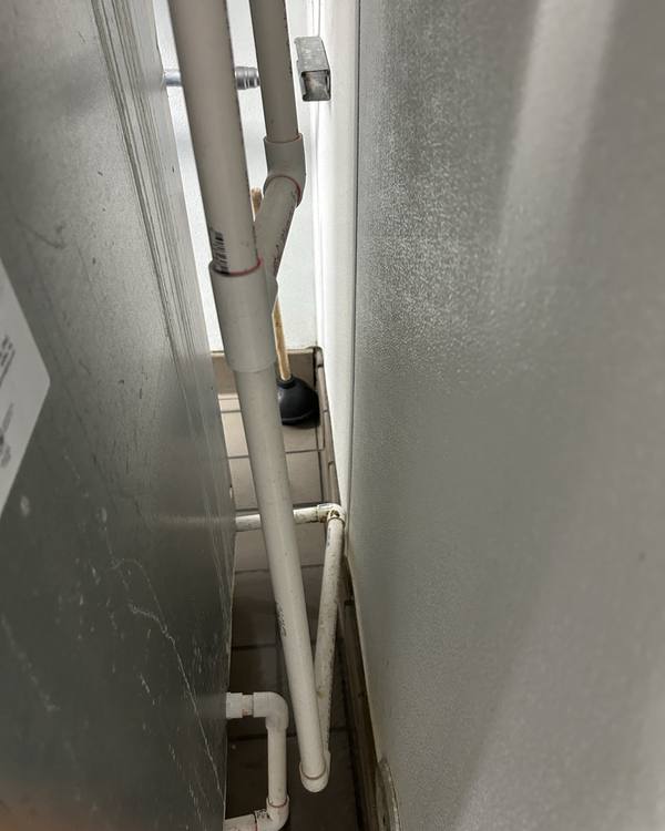 Drain pipe run along a kitchen wall