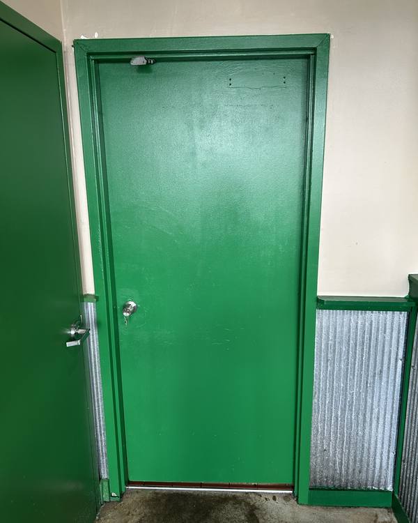Green service door and trim freshly painted
