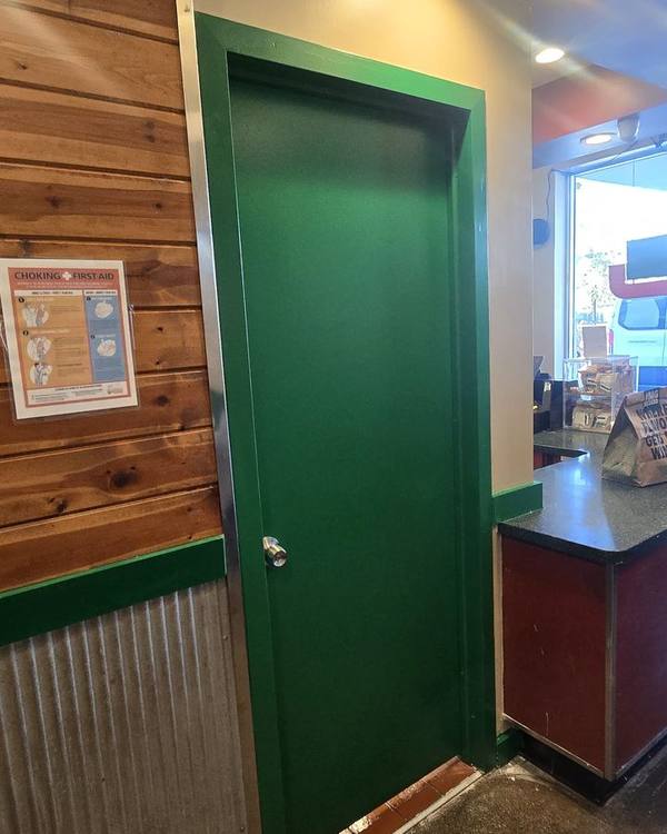 Freshly painted green door and trim in a restaurant
