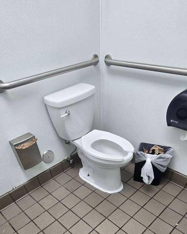Restroom with clean tile floor and accessible grab bars