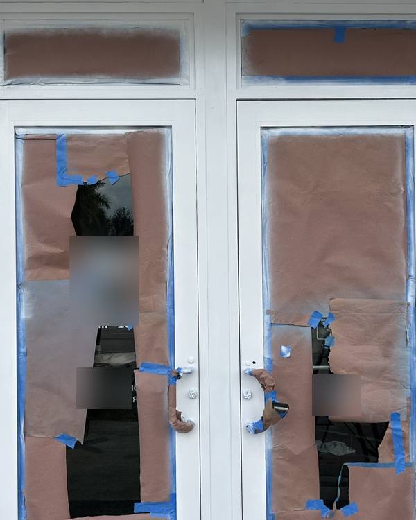 Glass storefront doors masked for frame painting