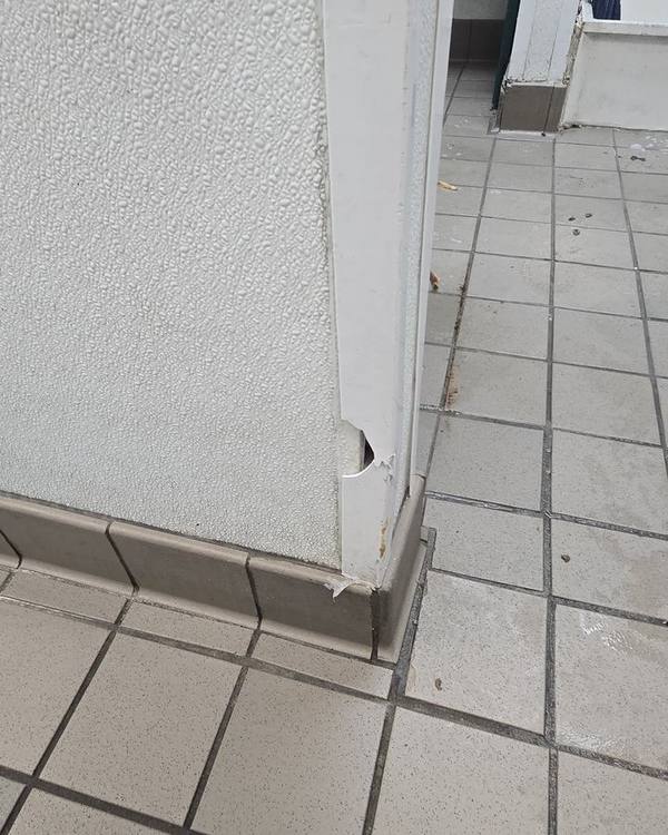 Damaged wall corner with a gouge at the base
